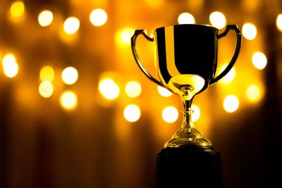 A golden trophy against a black and gold background